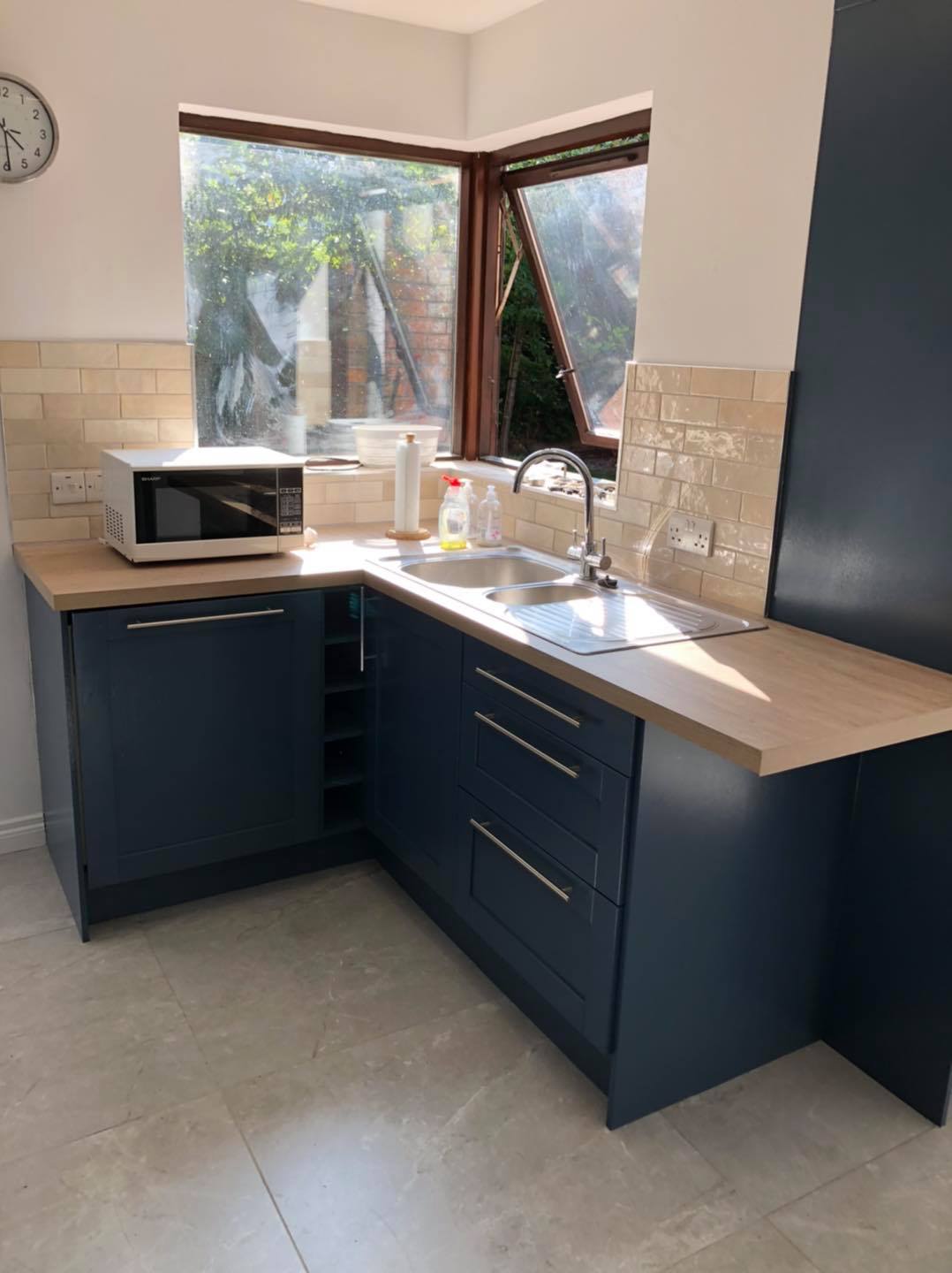 Navy painted corner cabinets with sink