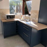 Navy painted corner cabinets with sink