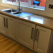 White Vinyl Wrapped Laminated Kitchen with chrome sink